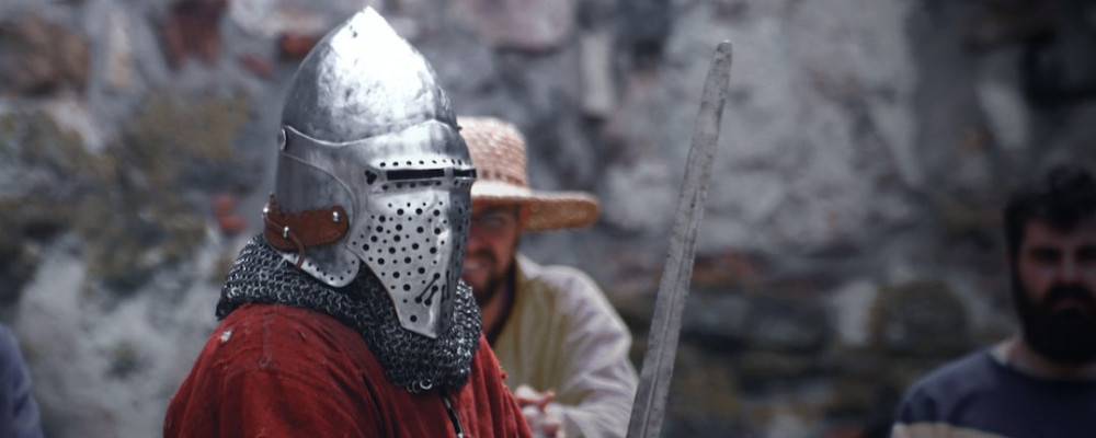 knight with red cape holding a sword