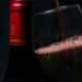 How do you identify a Blauer Zweigelt - A glass of red wine beside a bottle of red wine