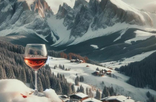 Wine retreats in the Alps - picture of a wine glass in front of mountains