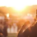 photo of a girl seen from the back in a festival during sunset