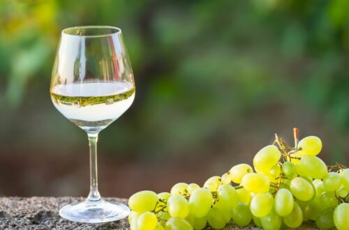 Clairette Grape Variety - picture of a glass of wine near a bunch of white grapes