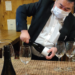 a japanese man opening a bottle of wine